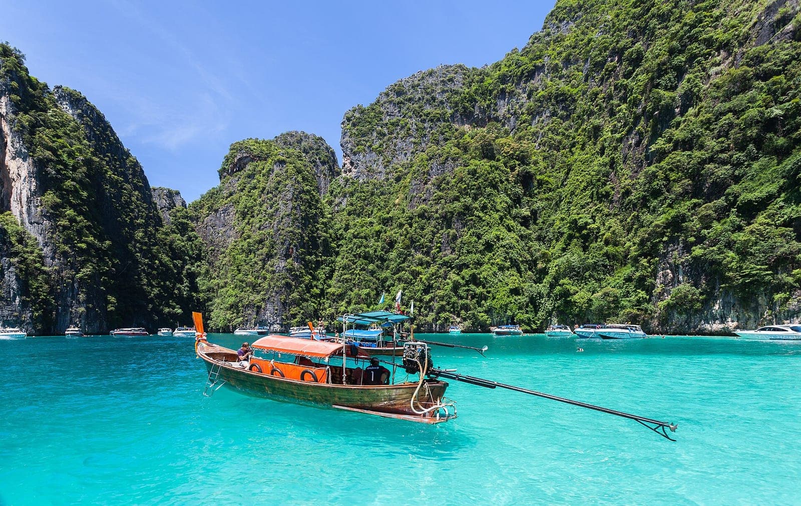 A long-tail boat beside Phi Phi’s limestone islands