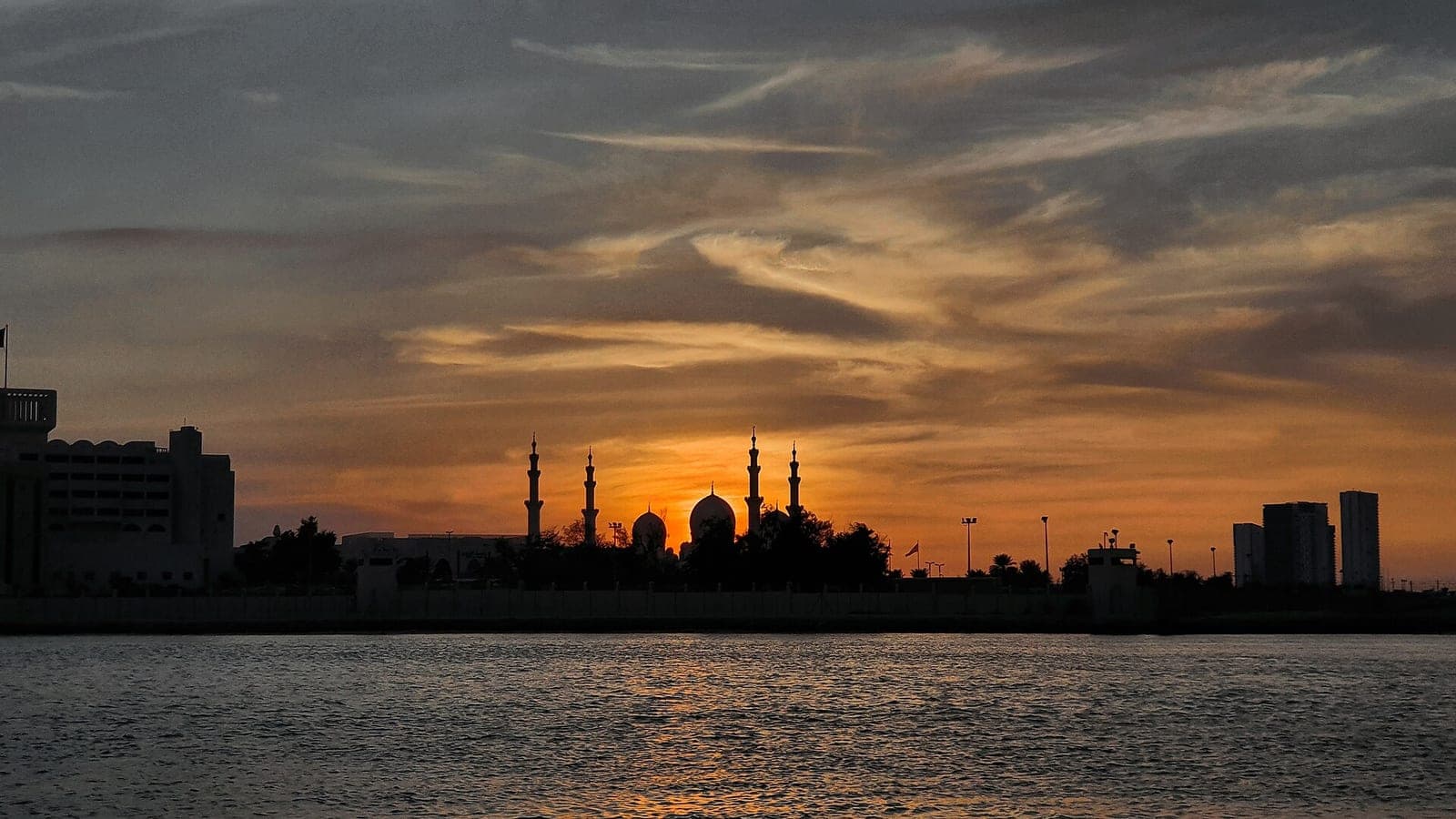 Sheikh Zayed Grand Mosque silhouetted at sunset